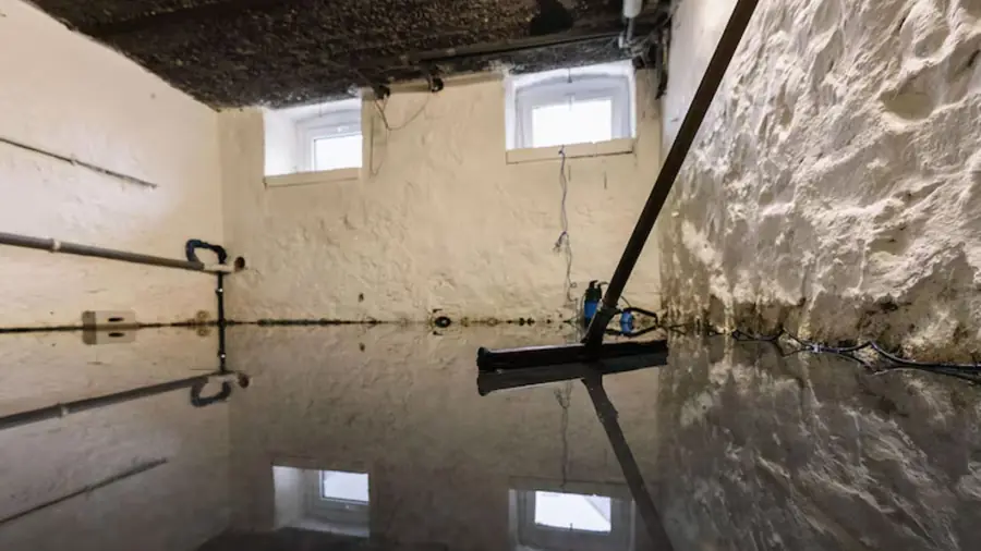 Basement floor covered in standing water after flooding