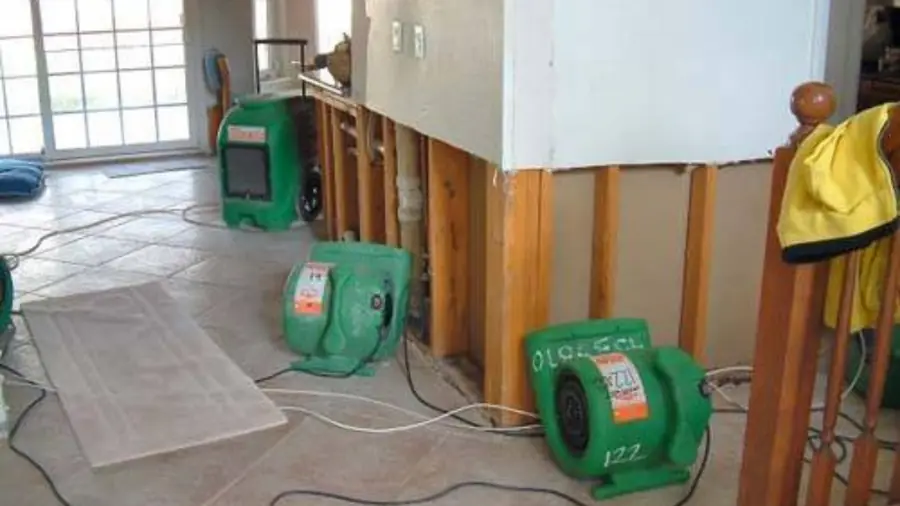 Wall opened at the base with air movers drying the floor