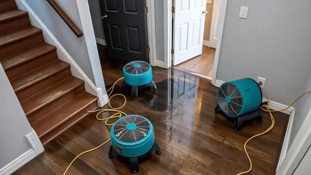 Drying fans running on a hardwood floor and staircase